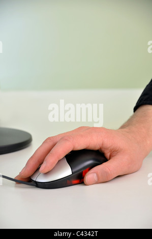 Man`s hand on computer mouse, close-up Stock Photo